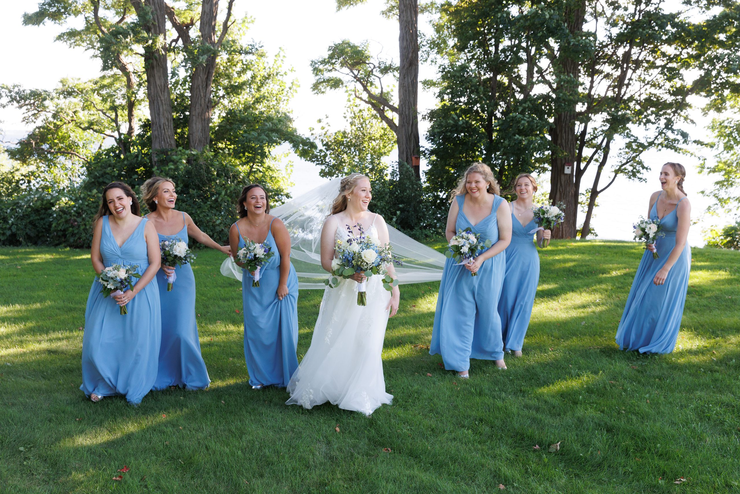 Bride and Bridesmaids sharing a moment after wedding in South Hero Vermont. 