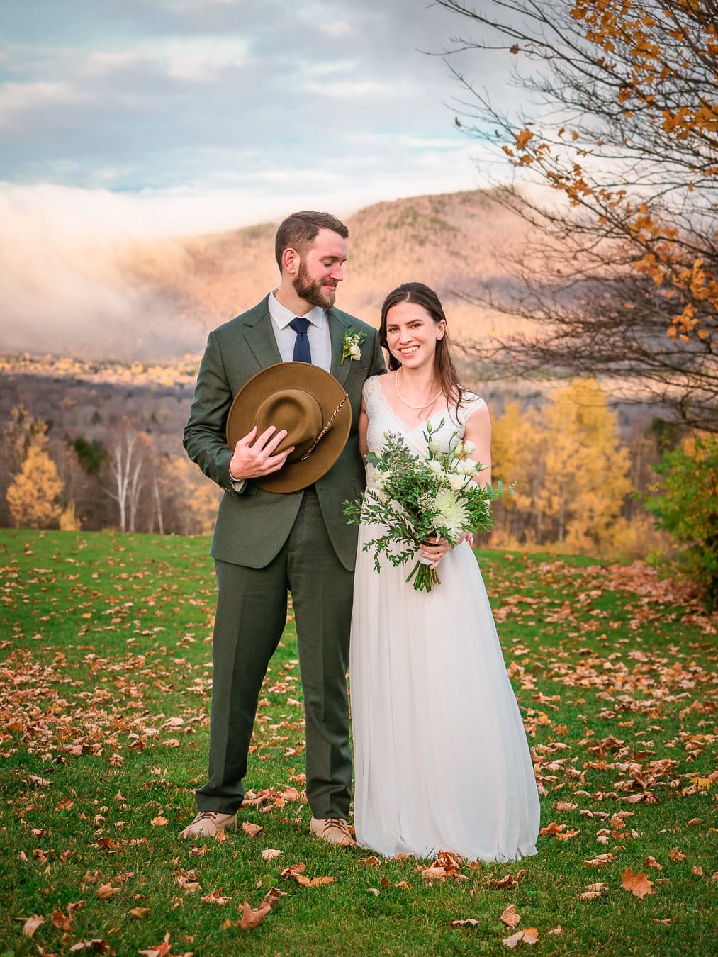 Couple sharing a first look with Vermont Green Mountains behind them, with colorful foliage. 